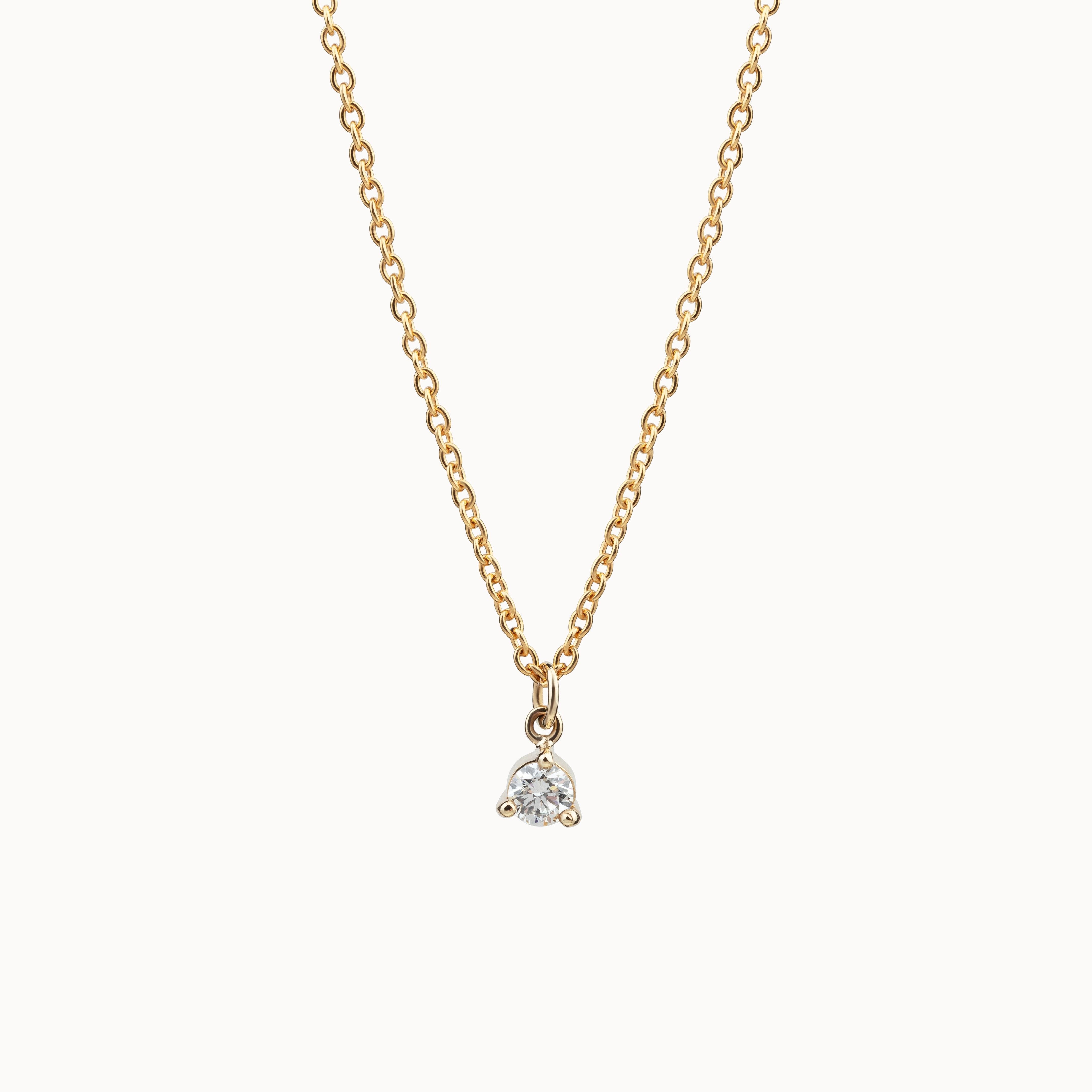 Gold and diamond necklace on a white background