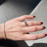 Hand with diamond bracelet and diamond engagement ring.