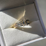 Ring box with an emerald cut diamond engagement ring.